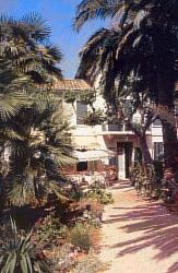 Entrée de l'hôtel Bon Abri au milieu du jardin